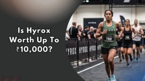 Woman in Hyrox race gear running on indoor track during competition, text reads "Is Hyrox Worth Up To ₹10,000?"