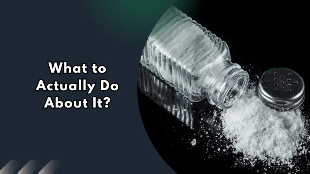 What-to-Actually-Do-About-It Glass salt shaker spilling salt onto a dark surface, representing practical steps to reduce microplastic exposure from salt and sugar