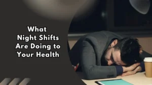 Person sleeping at a desk during a night shift, illustrating the health effects of working overnight shifts and disrupted sleep.